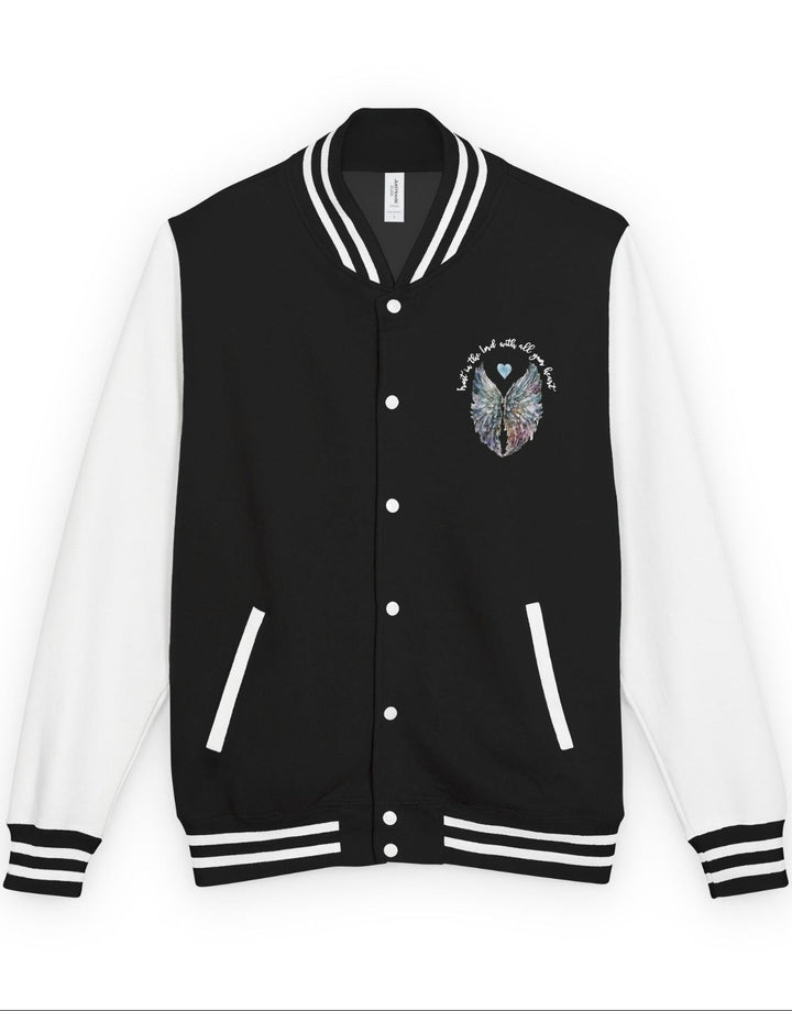 Black and white varsity jacket with a Trust in the Lord angel wings design on the chest against a white background