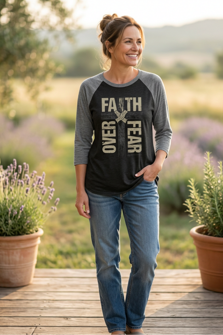 Woman wearing a 'Faith Over Fear' shirt standing in a lavender field.