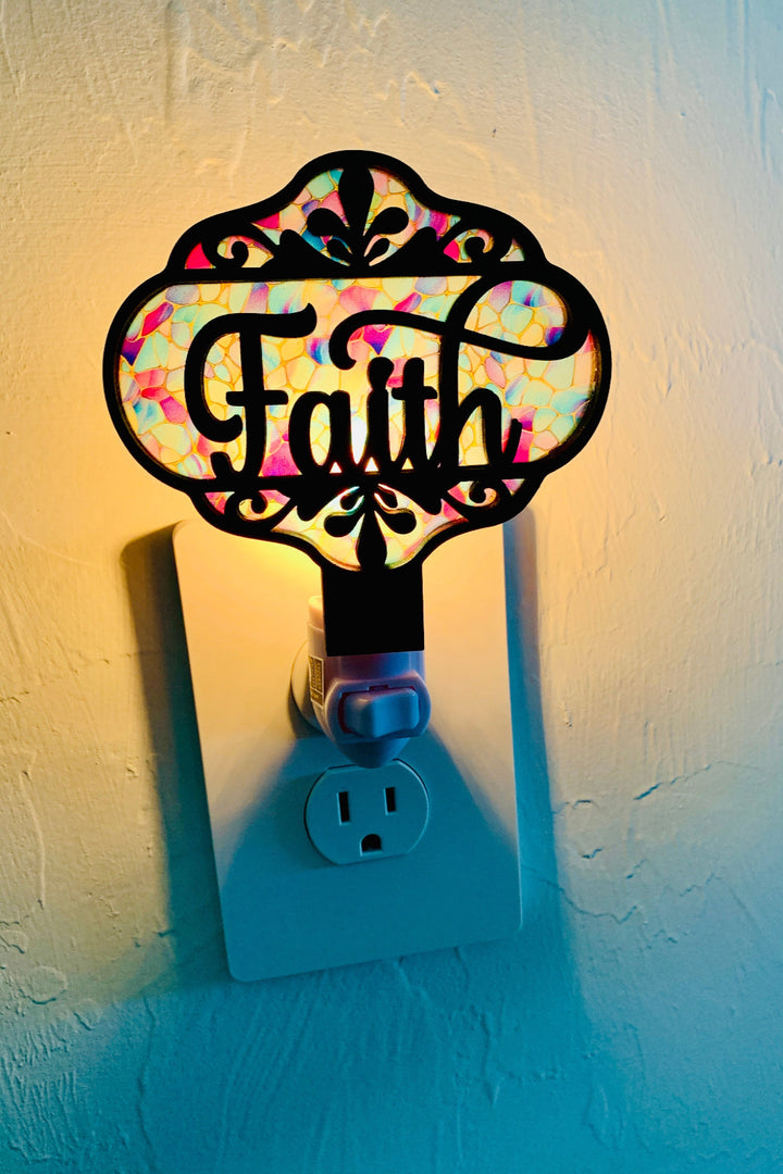 Decorative night light with 'Faith' text on a white wall