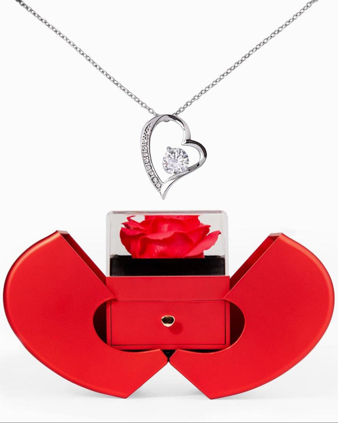 Red heart-shaped box with a rose and a silver heart pendant on a white background